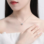 Sterling silver flower necklace with 1-carat moissanite gemstone, elegant jewelry piece with detailed floral design.