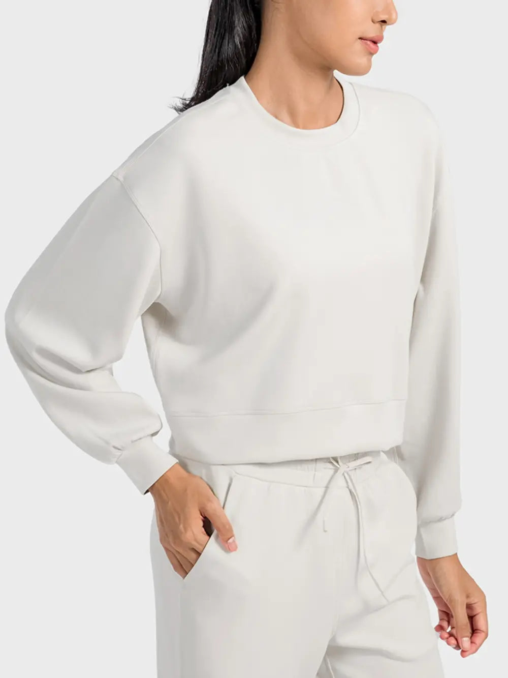 Millennia round neck drop shoulder sports top by Trendsi, featuring a comfortable fit and stylish design for activewear.