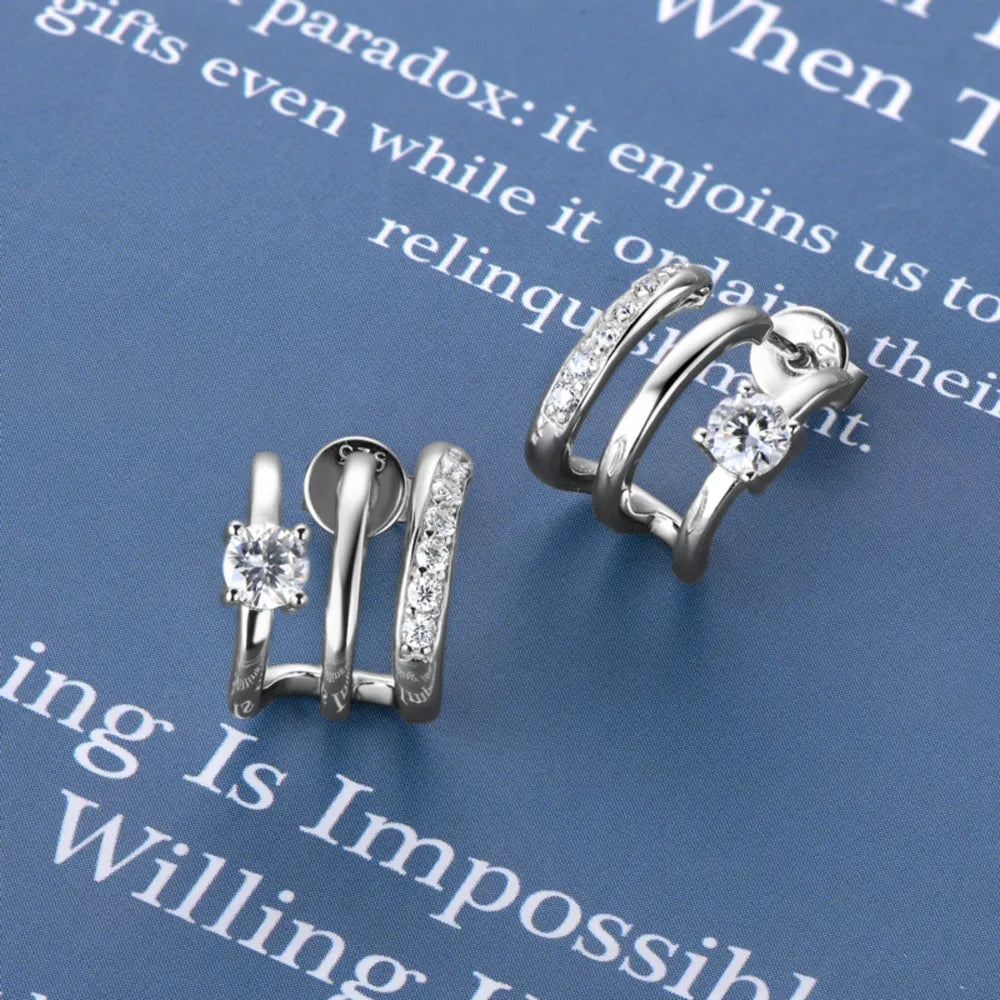 Sterling silver moissanite earrings with sparkling gemstone accents, stylish jewelry piece from Plush Fashion Hub.