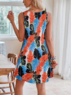 Tropical leaf print V-neck sleeveless dress by Shopimist hanging on a hanger with vibrant green and yellow foliage design.