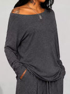 Plus size loose fit one-shoulder T-shirt and pants set by Trendsi, featuring comfortable, relaxed-fit casual wear.