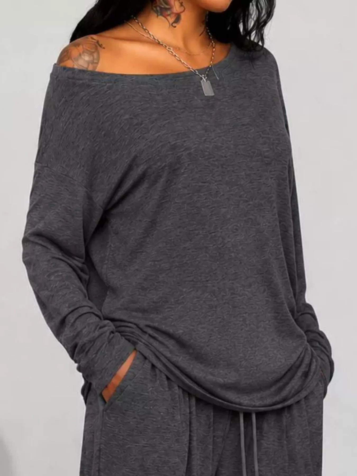 Plus size loose fit one-shoulder T-shirt and pants set by Trendsi, featuring comfortable, relaxed-fit casual wear.