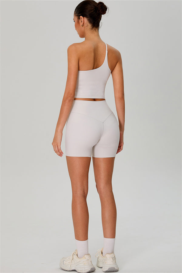 Fitglutes activewear two-piece set with one-shoulder crop top and matching shorts, designed for gym and workout activities.
