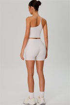 Fitglutes activewear two-piece set with one-shoulder crop top and matching shorts, designed for gym and workout activities.