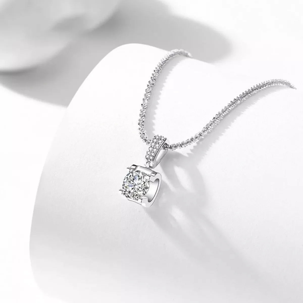 Sterling silver moissanite necklace with 1-carat center stone, elegant jewelry piece from Plush Fashion Hub.