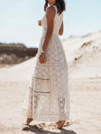 Ethereal V-neck lace sleeveless maxi dress with tassel accents, flowing fabric, and elegant design, perfect for special occasions