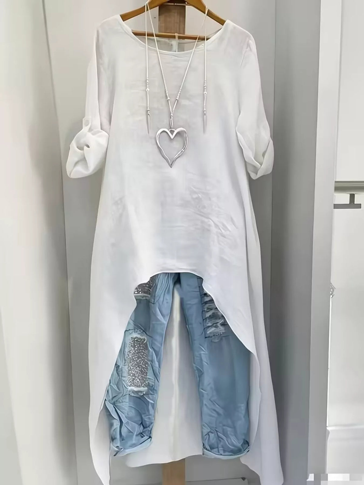 High-low hem blouse with roll-up sleeves from Trendsi, featuring a stylish, flowy design and casual-chic look.