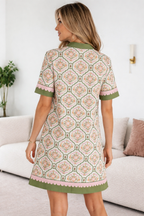 Floral Threaded Pear Galilea Sleeve Loose Mini Dress with long sleeves and a relaxed fit, shown from the back.