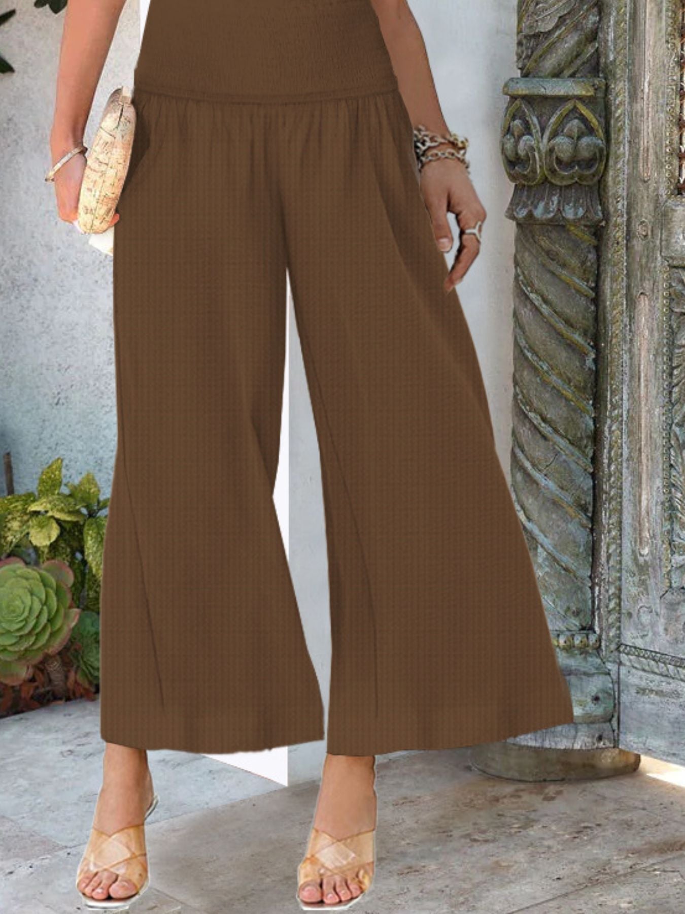 Women's lightweight wide-leg smocked waist casual trousers from Trendsi, showing relaxed fit and soft fabric.