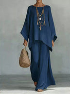 Plus size full size round neck top and wide leg pants set by Trendsi, featuring a comfortable matching pant set with a relaxed fit.