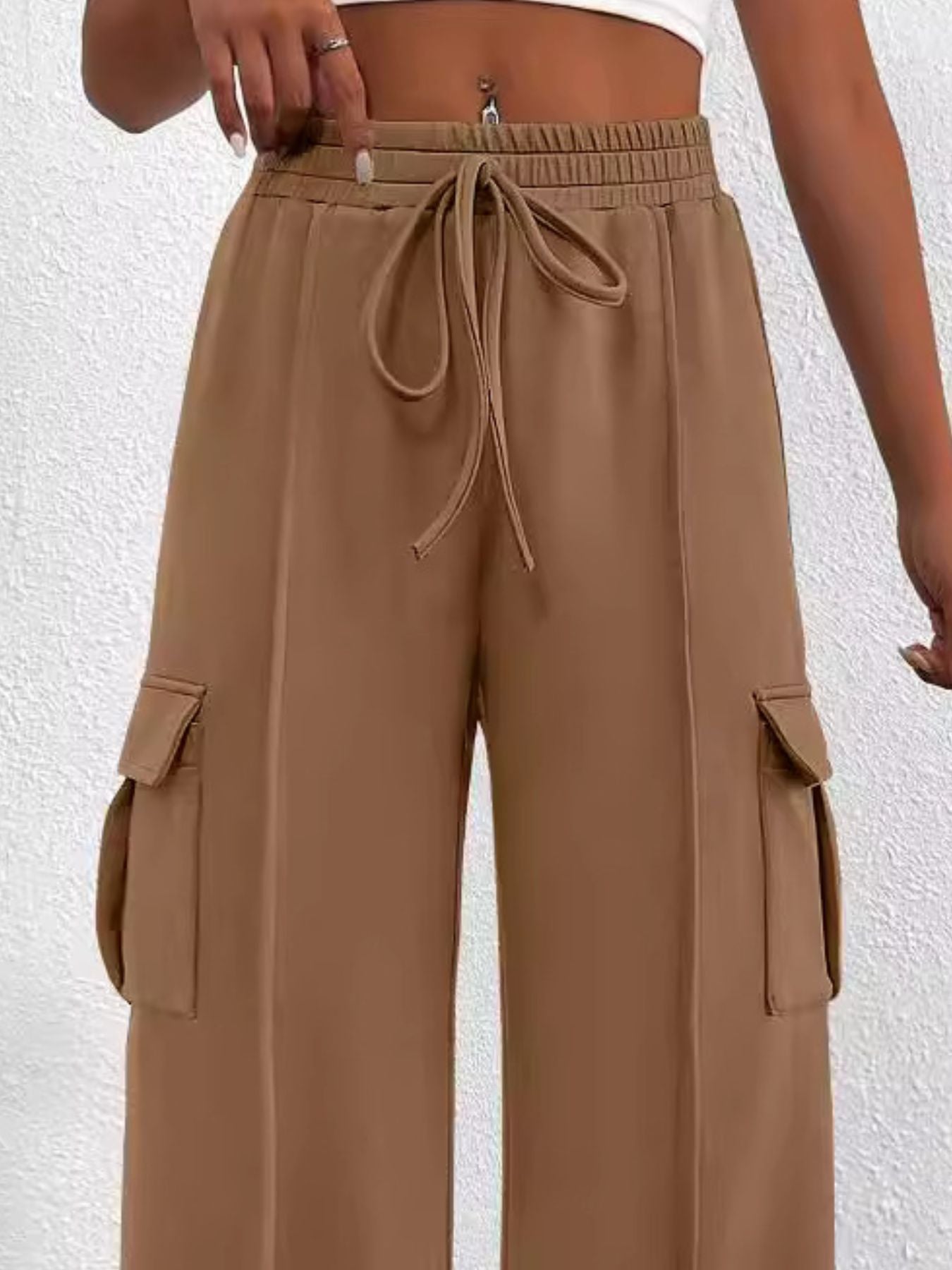 Women's high-waisted casual cargo pants with drawstring from Trendsi, lightweight utility pants with multiple pockets and relaxed fit.