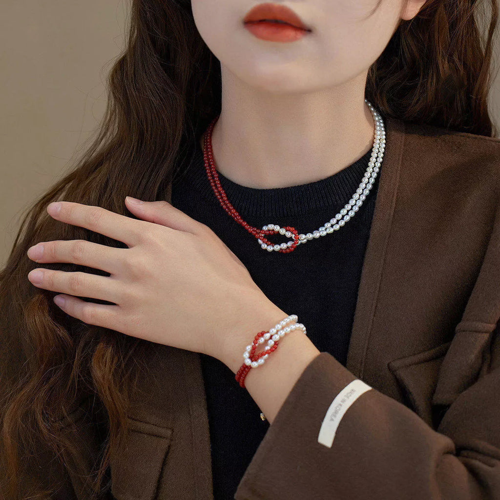 Double layered knot necklace from Shopimist featuring intertwined chain design on a neutral background.
