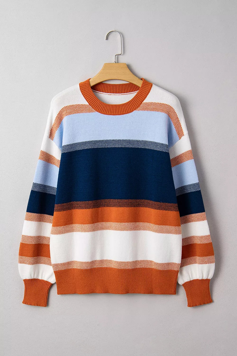 Color block round neck tunic sweater by Trendsi showing a cozy knit sweater with bold color blocks and a rounded neckline.