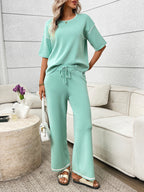 Women's casual two-piece lounge set with round neck top and drawstring pants, stylish and comfortable from Trendsi.