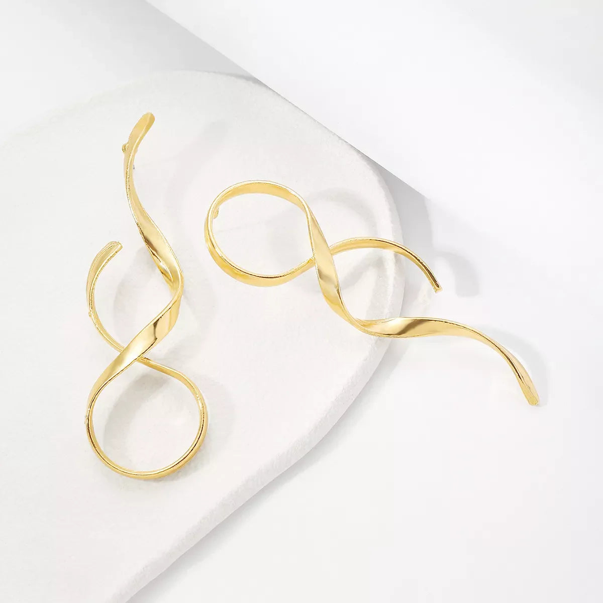 Shopimist alloy spiral drop earrings featuring sleek, curved metal design hanging from delicate hooks.