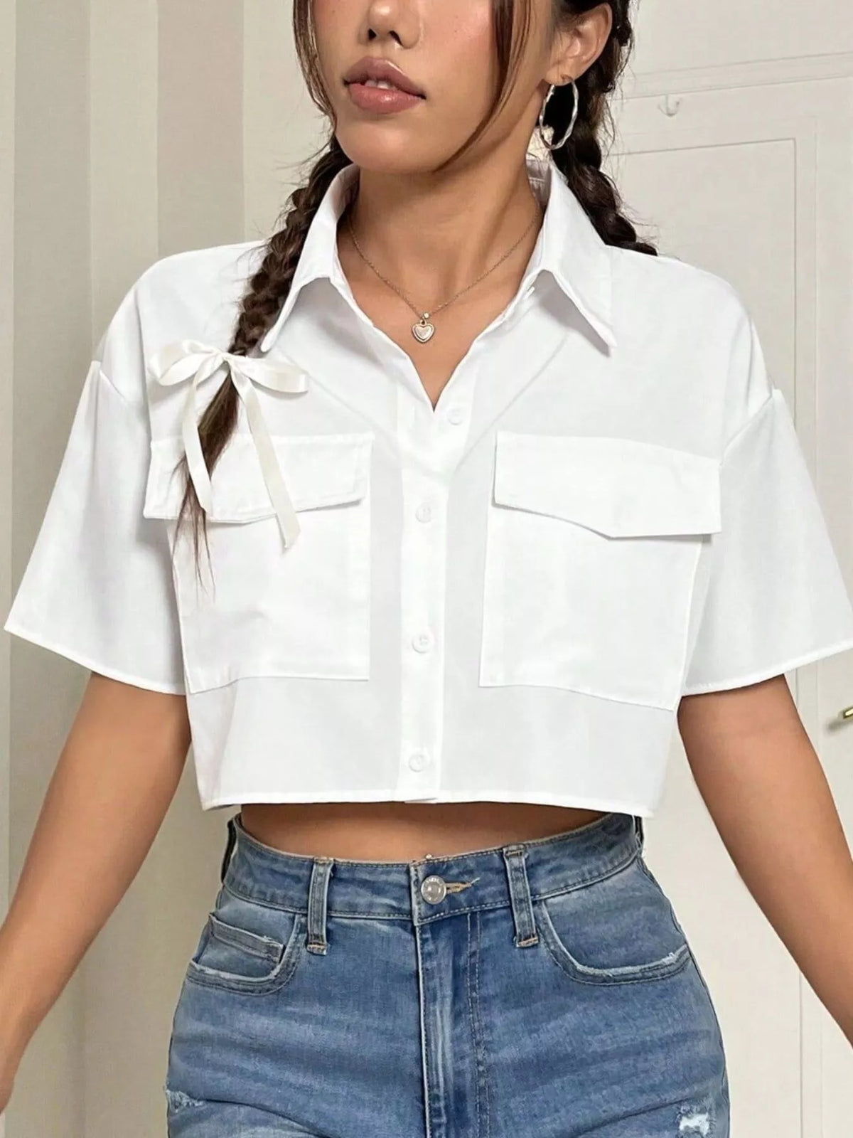 Short sleeve crop shirt with chest pockets from Trendsi, featuring a stylish and casual tops design in a lightweight fabric.