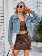 VYSN raw hem denim jacket with front pockets, casual fashion clothing, shown on a hanger with rolled cuffs and distressed details.
