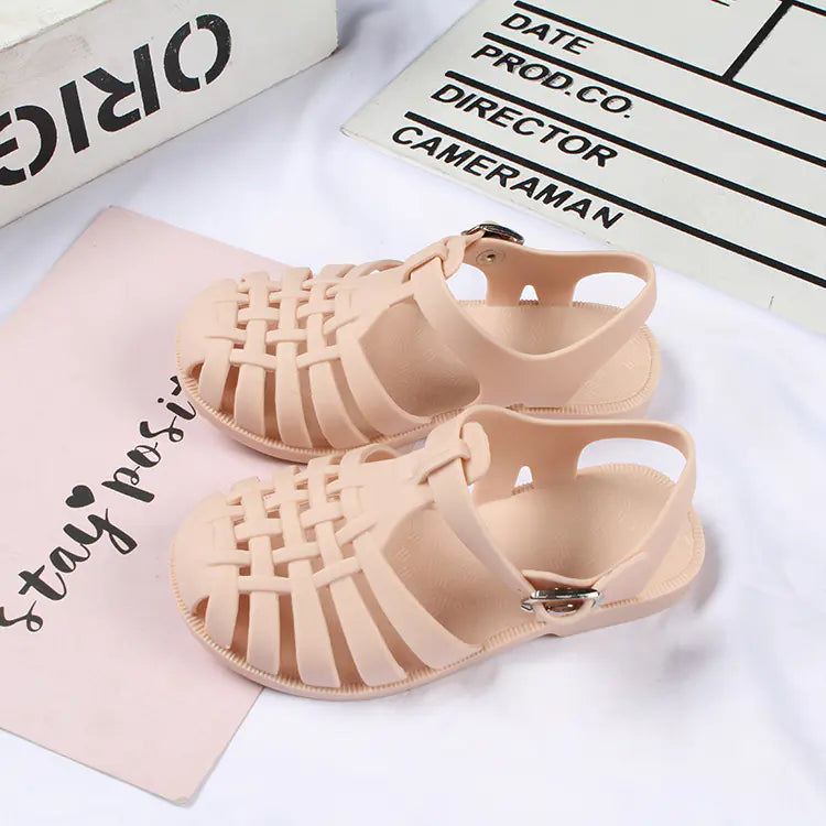 Girls hollow casual flat sandals by Trendy Attic Store01, featuring open toes and strap design, suitable for boys and girls.