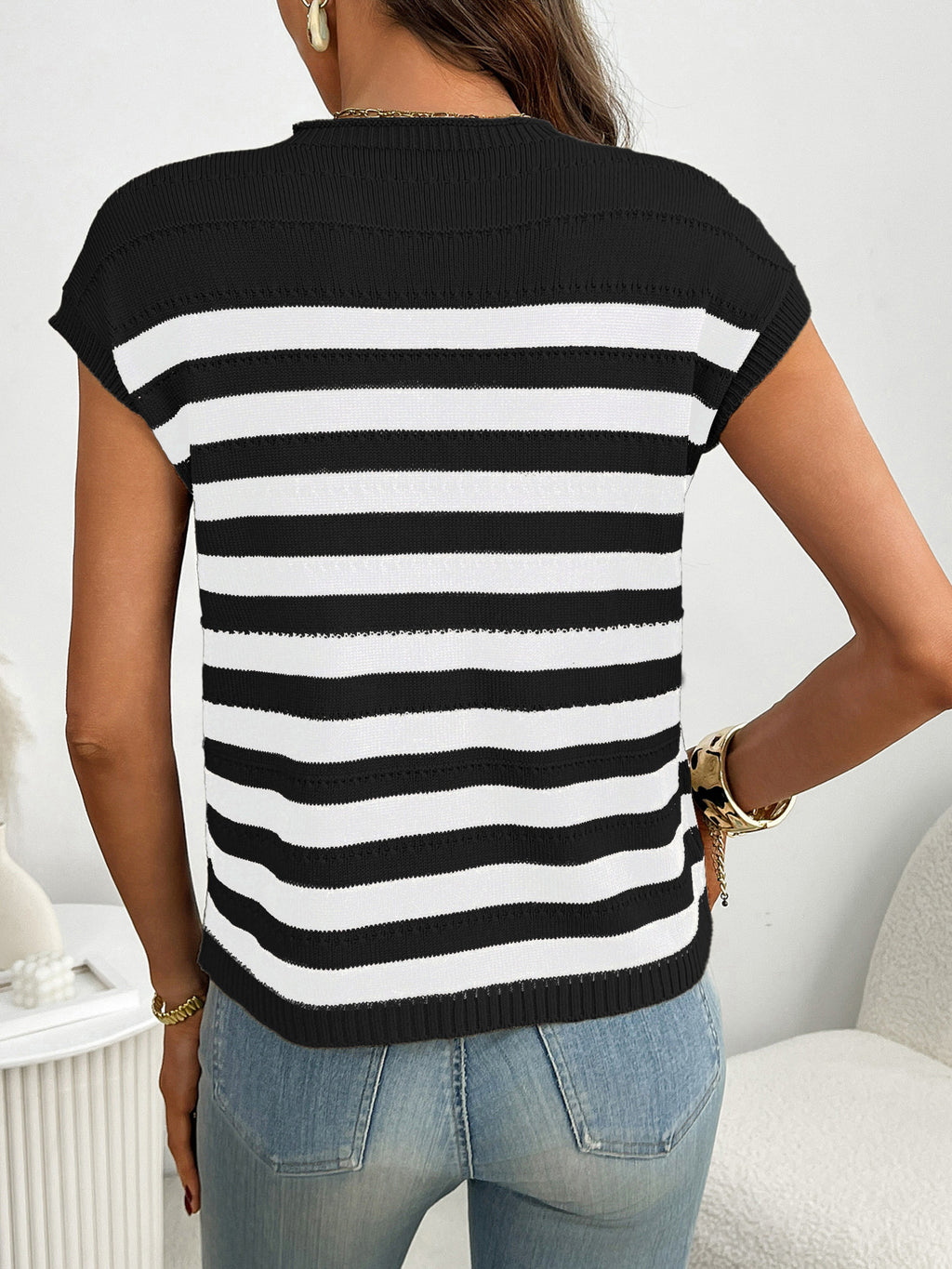 Women's striped knit cap sleeve sweater with pocket detail, trendy outerwear by Trendsi, displayed on a hanger.