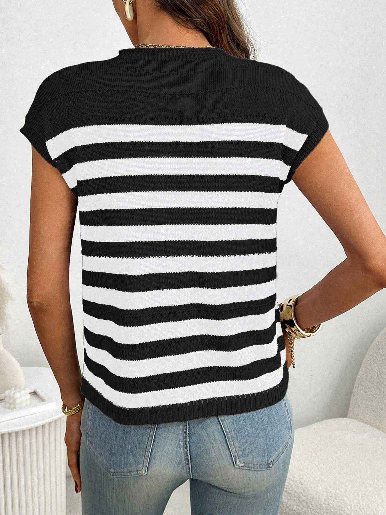 Women's striped knit cap sleeve sweater with pocket detail, trendy outerwear by Trendsi, displayed on a hanger.