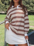 Striped long sleeve polo top with button details from Trendsi, featuring a classic design and comfortable fit.