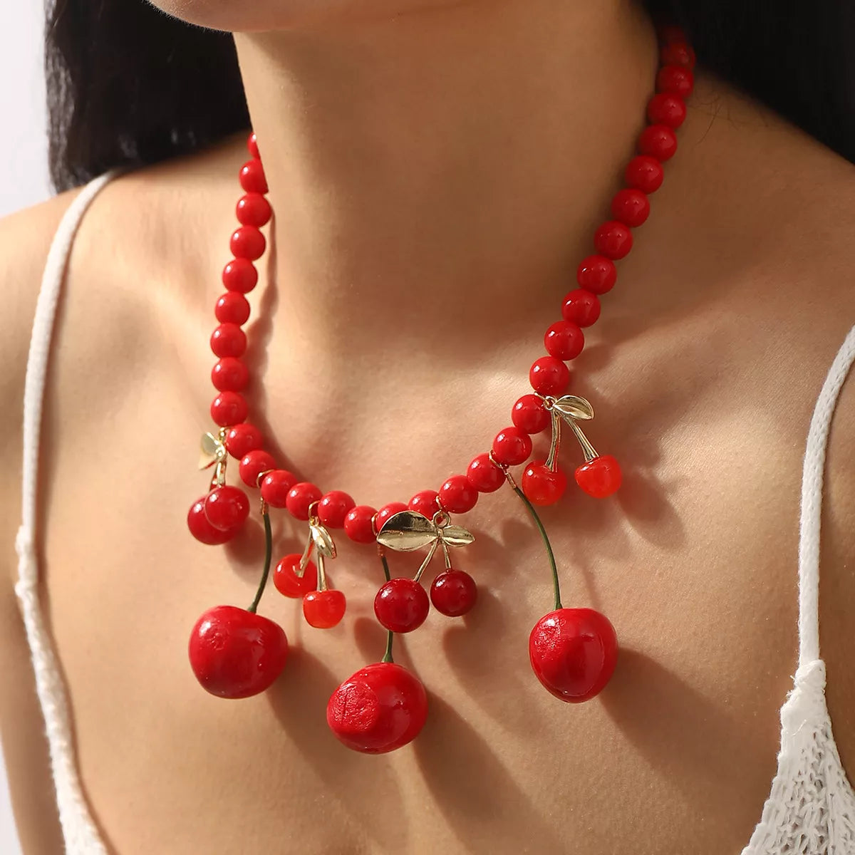 Beaded cherry charm statement necklace from Plush Fashion Hub featuring vibrant red cherry beads and intricate design.