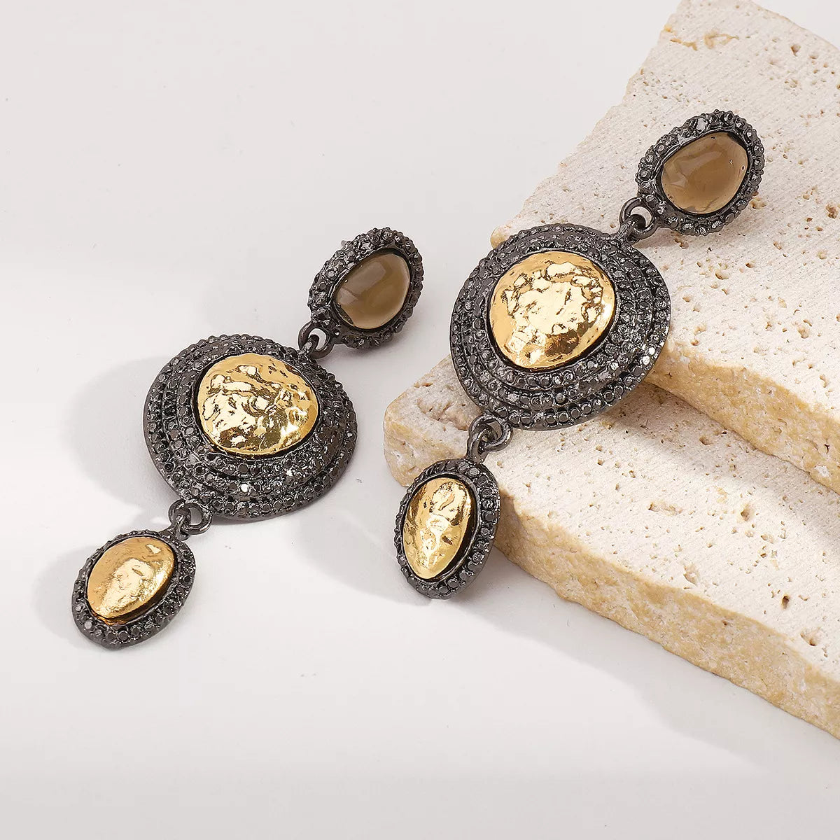 Vintage-inspired gold accent dangle earrings with intricate detailing, stylish jewelry piece by Plush Fashion Hub.