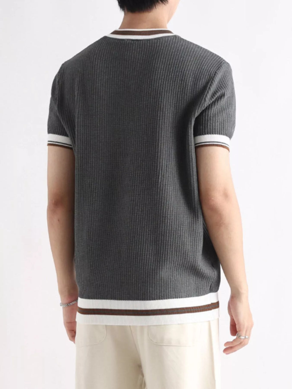 Plus size men's T-shirt with contrast trim, short sleeves, and trendy design, from Trendsi, shown on a model.