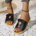 Women's casual open-toe faux leather flats with cutout details, designed for comfortable summer wear.