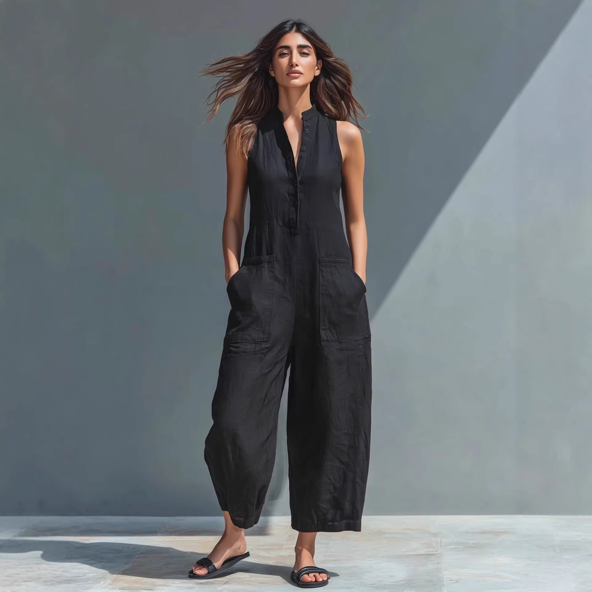 Casual women's sleeveless jumpsuit with buttoned stand collar and loose fit by Plush Fashion Hub, suitable for everyday wear.