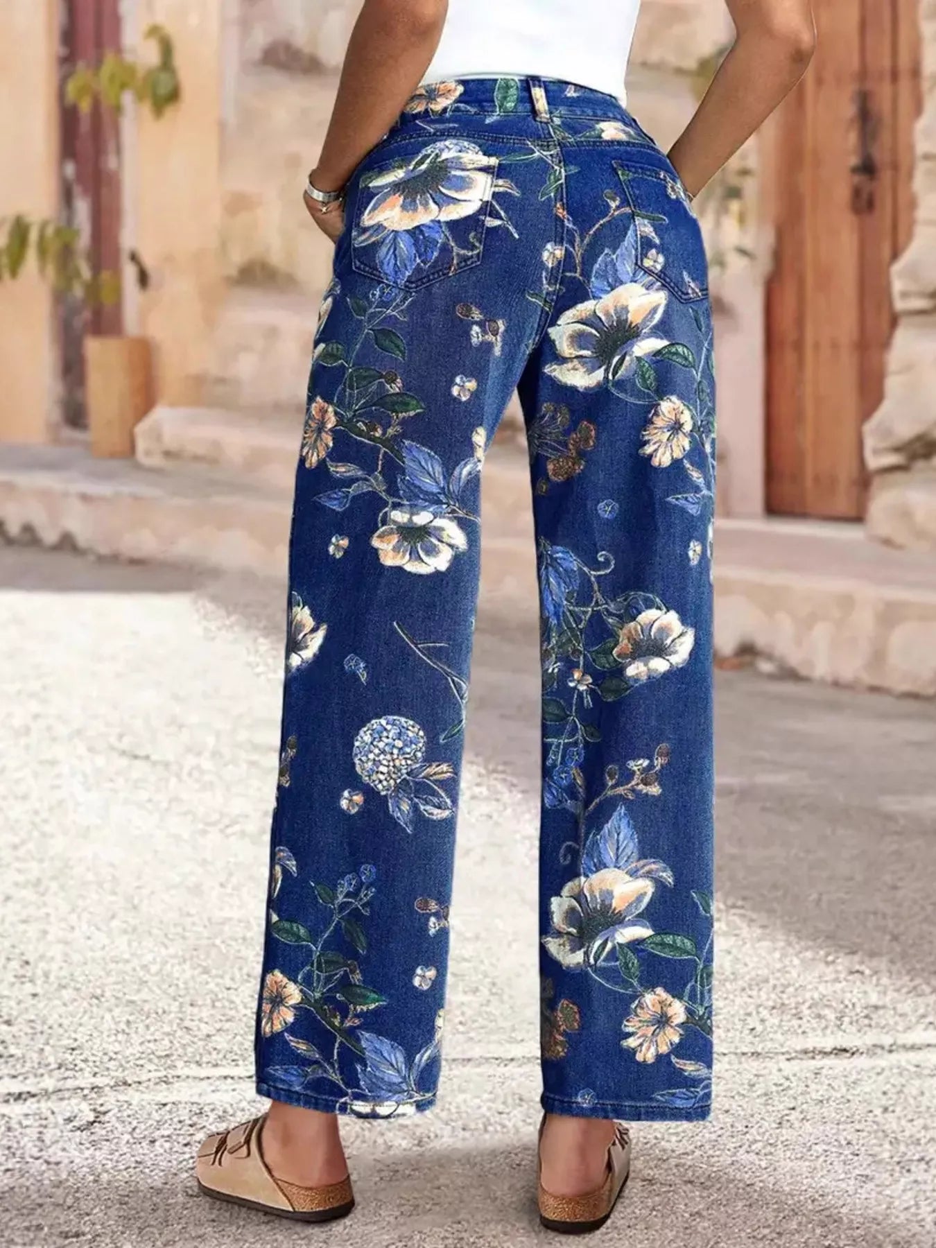 Floral print wide leg jeans by Trendsi, featuring a relaxed fit and vibrant floral pattern, perfect for casual and stylish looks.