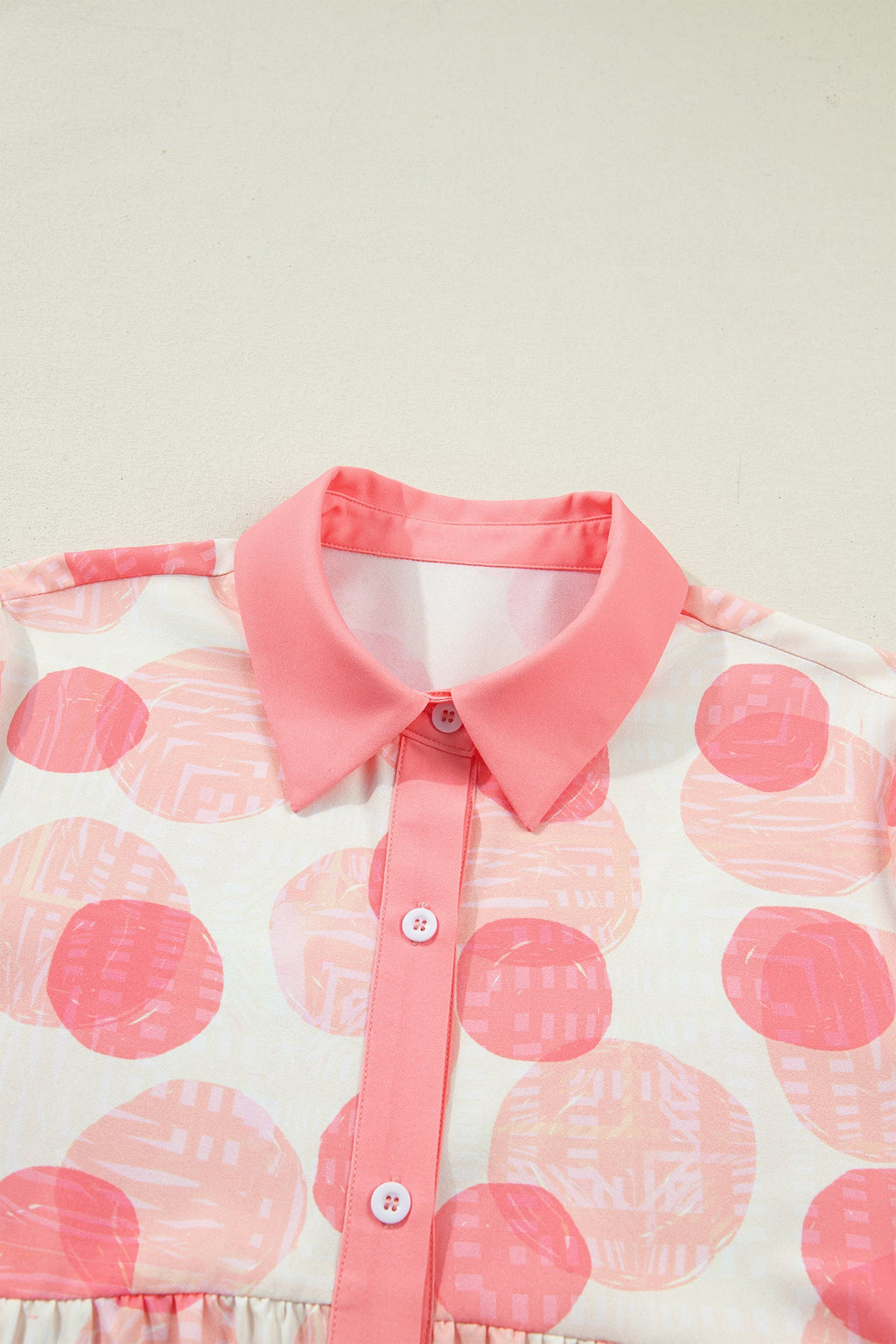 Threaded Pear Angelica short sleeve babydoll blouse with flowy fabric and relaxed fit, displayed on a hanger.