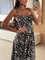 Women's striped tie-shoulder midi dress by Trendsi, casual summer dress with a relaxed fit and stylish design.
