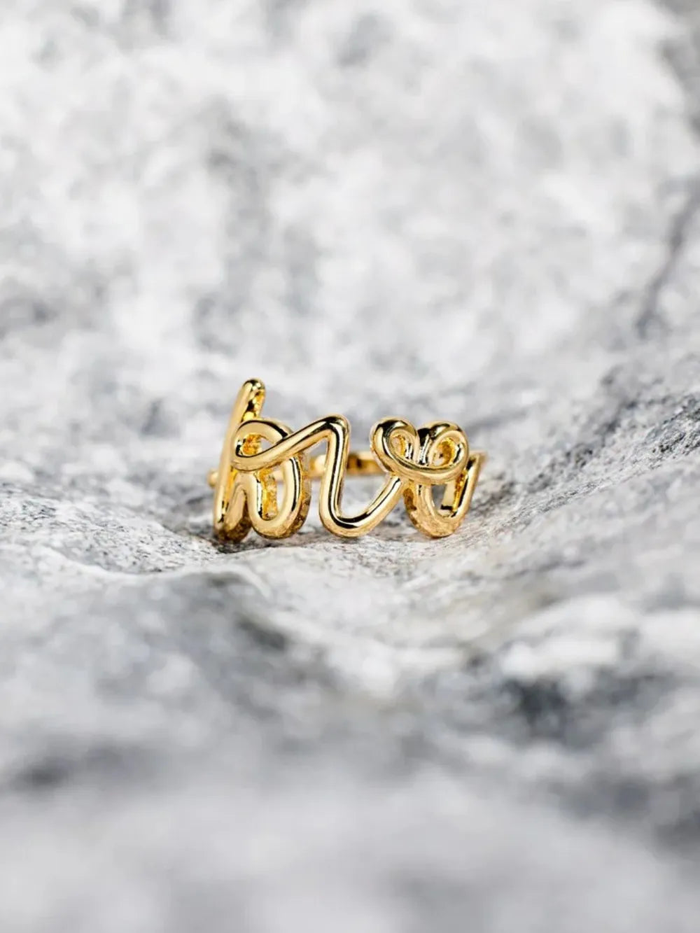 LOVE 18K gold-plated sterling silver ring with a sleek design, featuring a polished finish and subtle branding details.