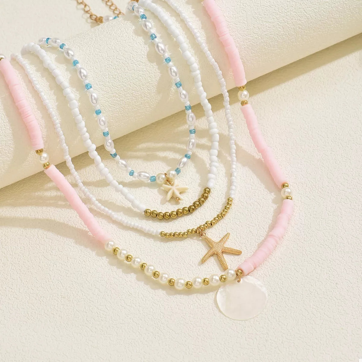 Four-piece beaded starfish charm necklace set from Plush Fashion Hub featuring colorful, nautical-inspired jewelry with starfish pendants.