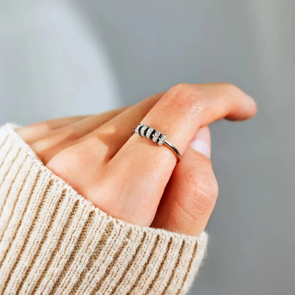 Sterling silver ring with inlaid zircon stones from Shopimist, showcasing detailed craftsmanship and sparkling gemstone accents.
