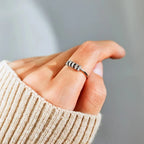 Sterling silver ring with inlaid zircon stones from Shopimist, showcasing detailed craftsmanship and sparkling gemstone accents.