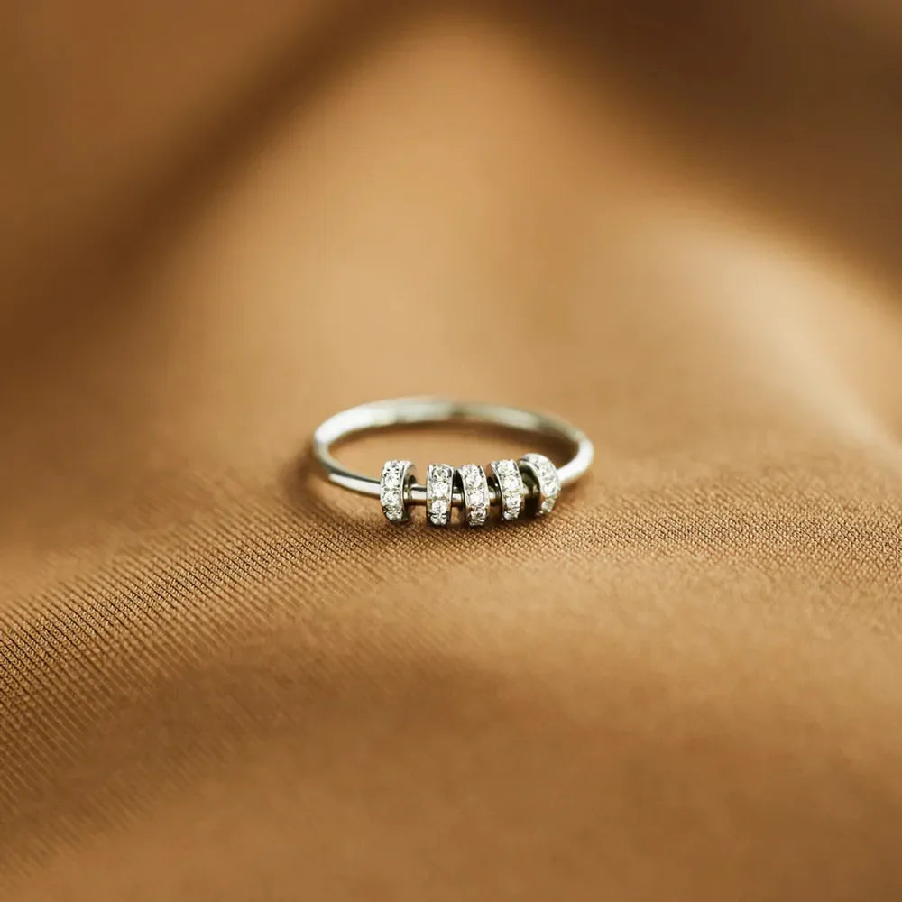 Sterling silver ring with inlaid zircon stones, crafted in 925 silver, featuring a detailed and elegant design.
