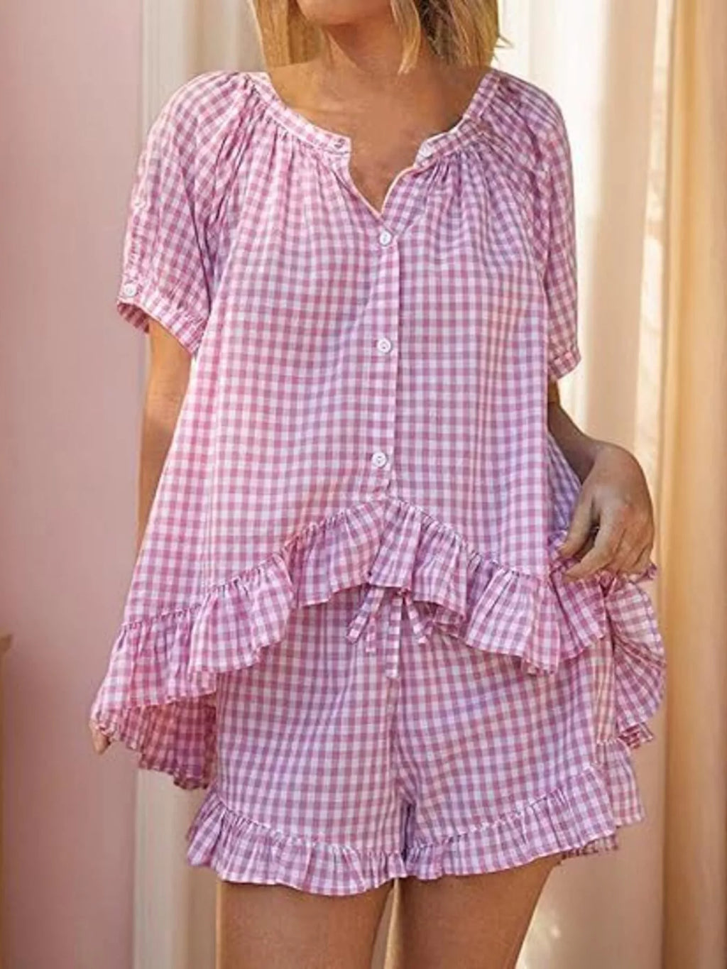 Gingham ruffle trim top and shorts set by Trendsi, featuring a stylish matching outfit with ruffle details and classic gingham pattern.