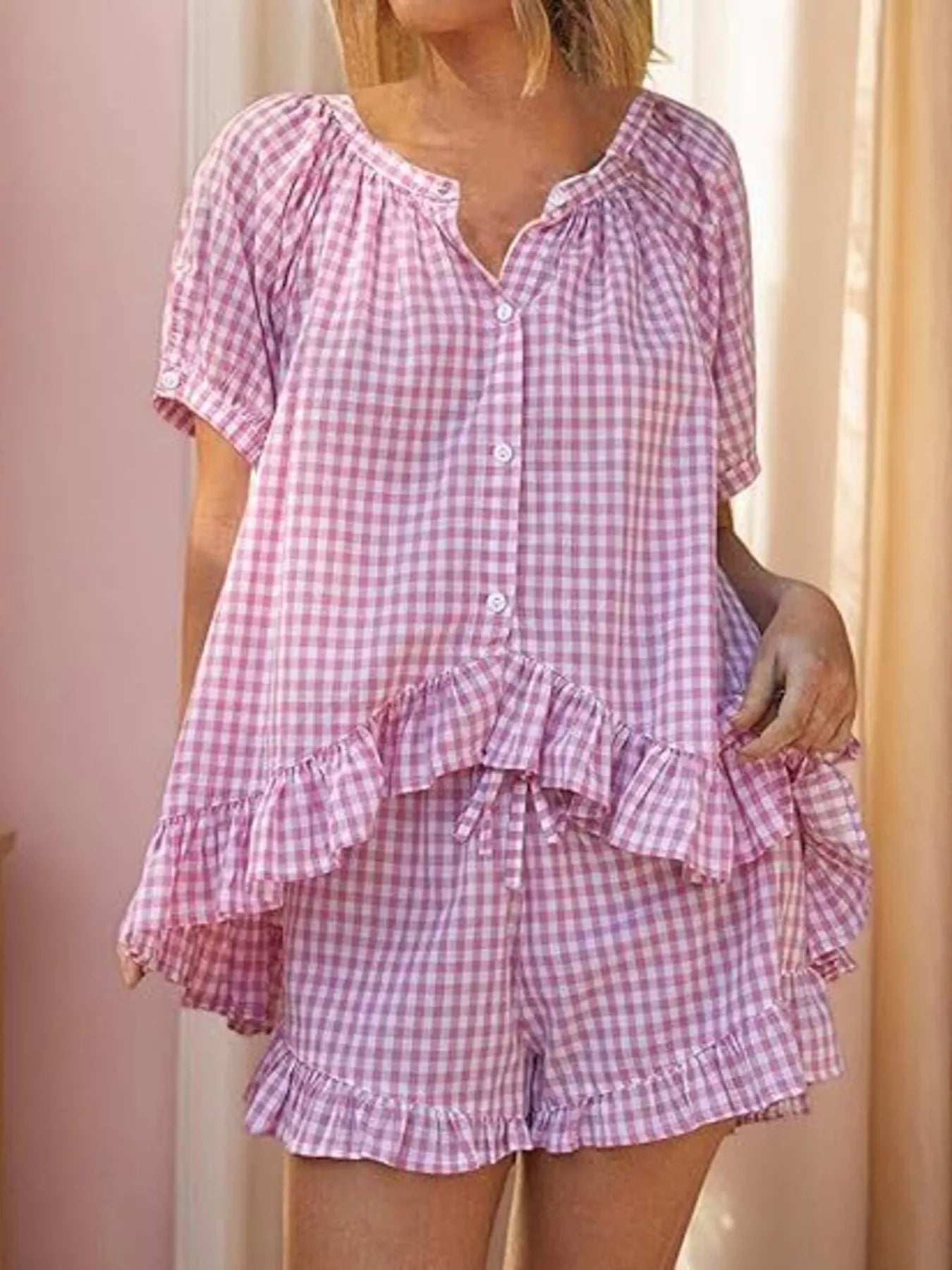 Gingham ruffle trim top and shorts set by Trendsi, featuring a stylish matching outfit with ruffle details and classic gingham pattern.