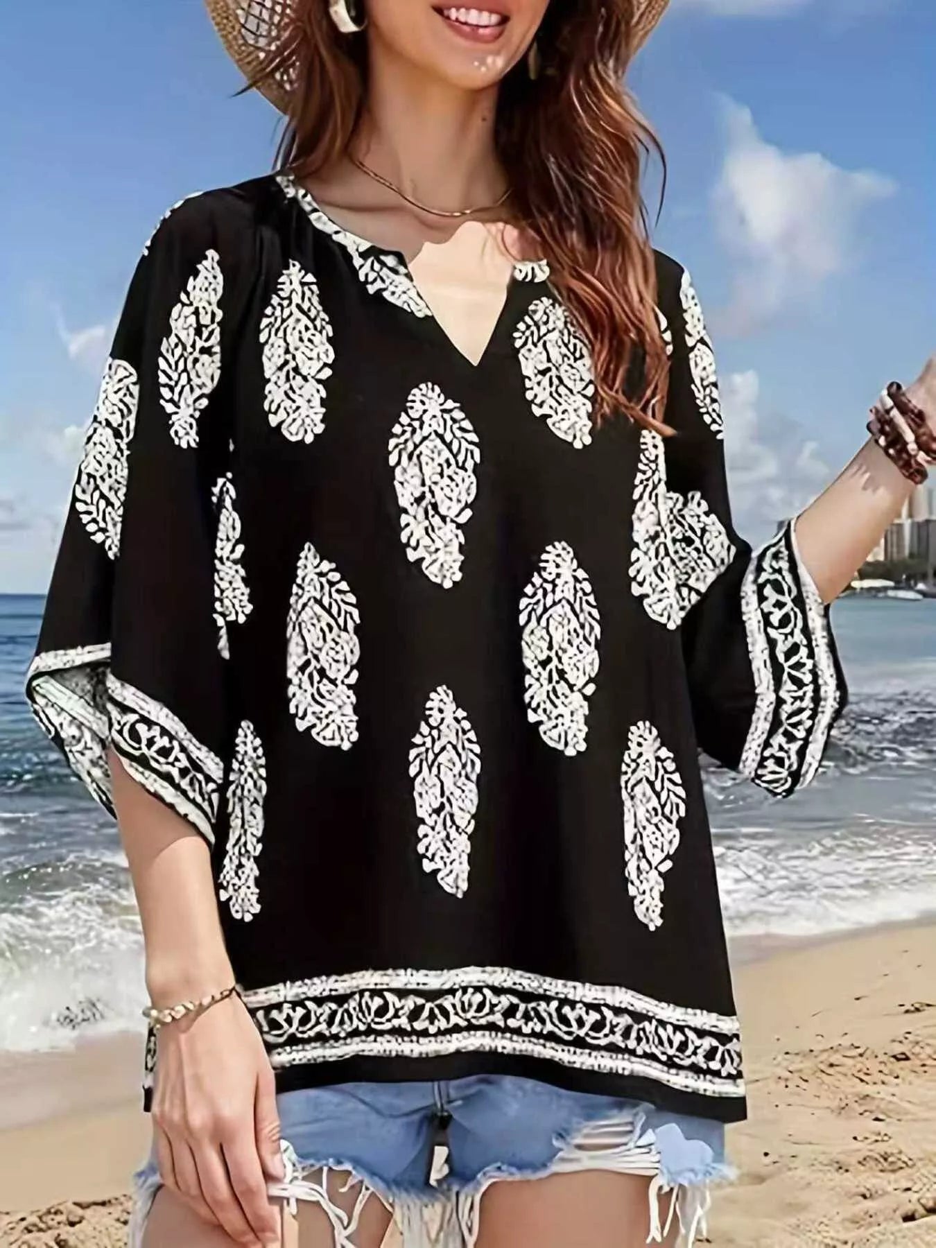 Printed notched 3/4 sleeve blouse from Plush Fashion Hub, featuring a stylish design and comfortable fit.