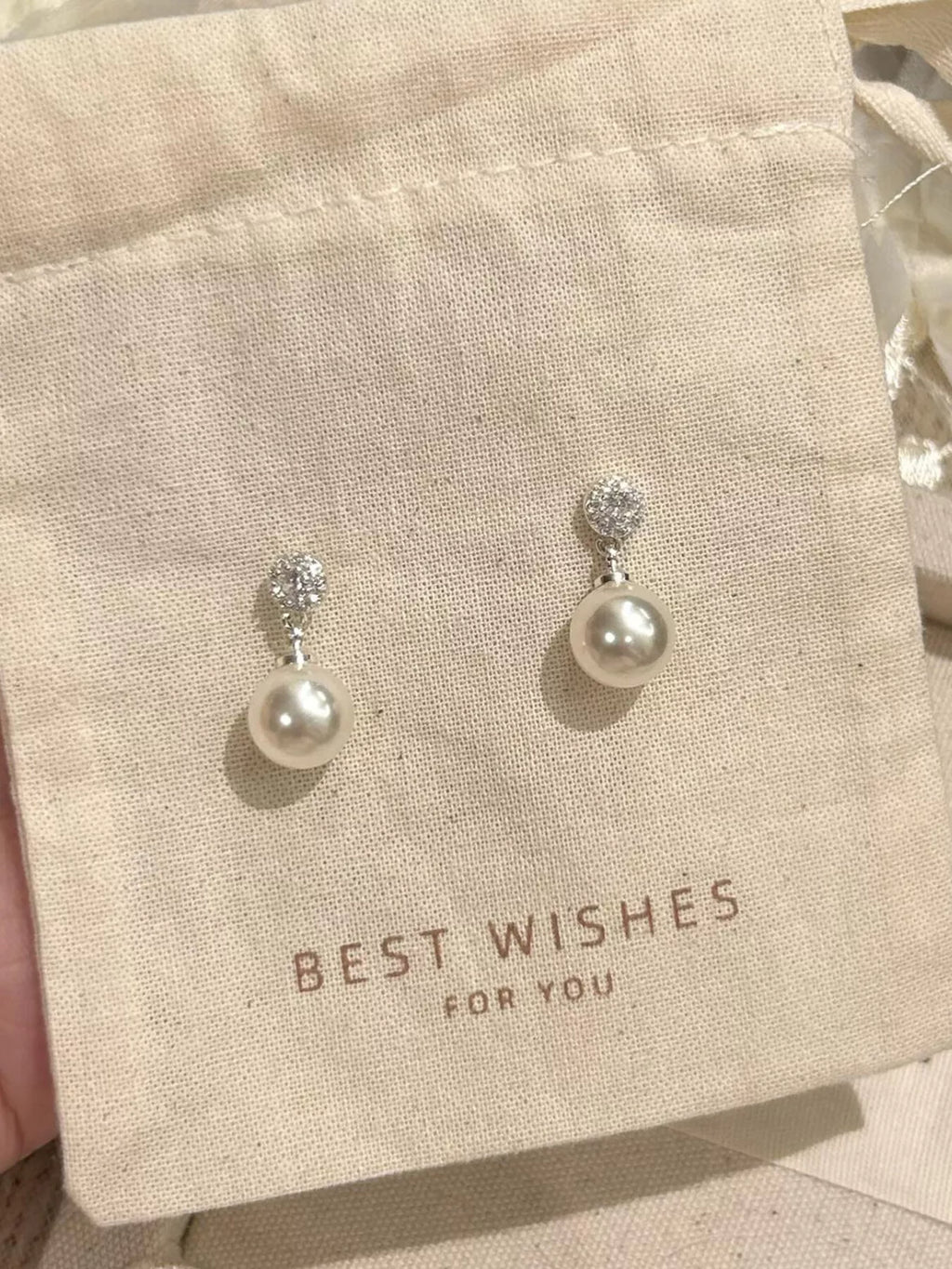 Elegant pearl drop earrings by Shopimist featuring classic white pearls and silver hooks, perfect for sophisticated style.