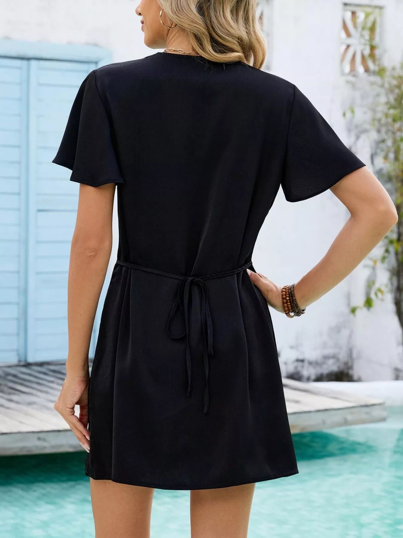 Women's notched flutter sleeve mini dress by Trendsi, casual summer shift dress with stylish design and comfortable fit.