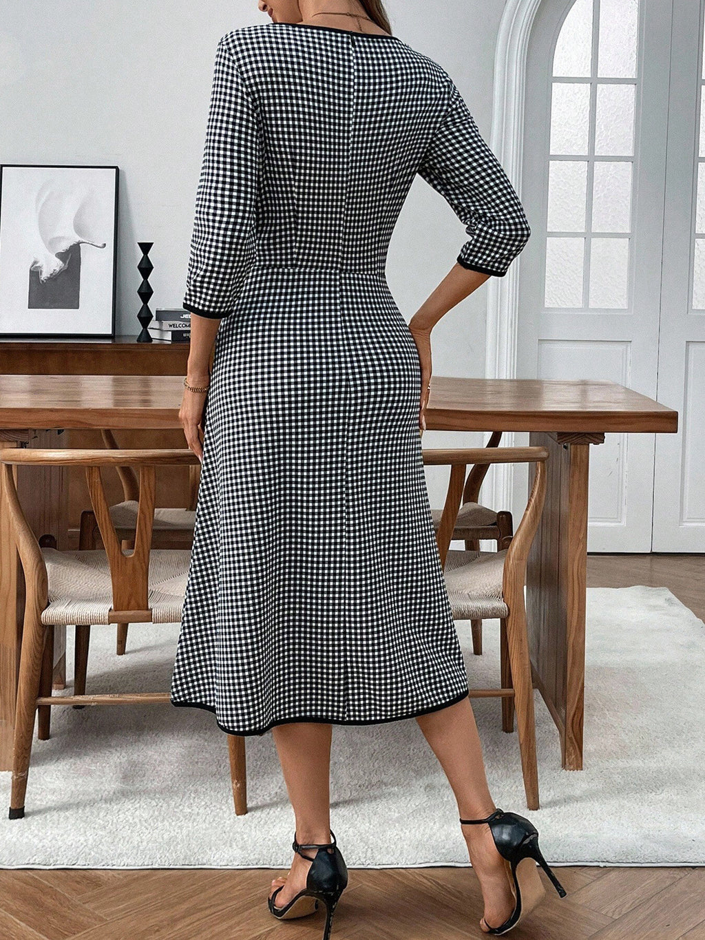Classic plaid round neck midi dress with 3/4 sleeves from Trendsi, featuring a stylish and comfortable design perfect for casual wear.