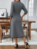 Classic plaid round neck midi dress with 3/4 sleeves from Trendsi, featuring a stylish and comfortable design perfect for casual wear.
