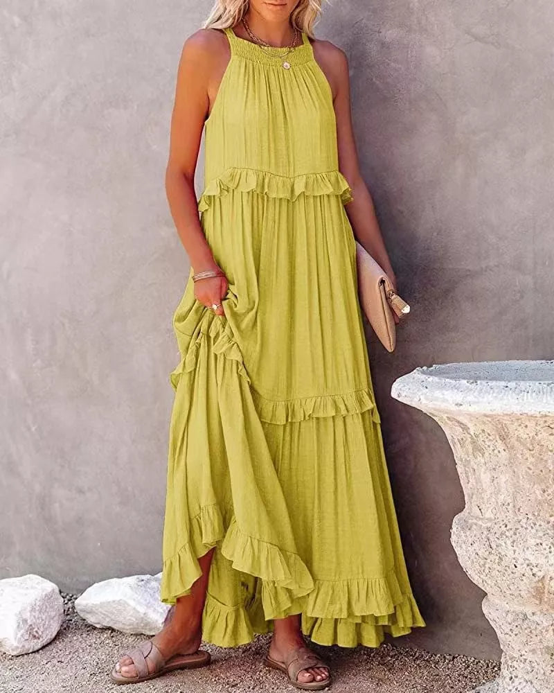 Ruffled tiered sleeveless maxi dress from Plush Fashion Hub featuring flowing fabric and feminine ruffle details.