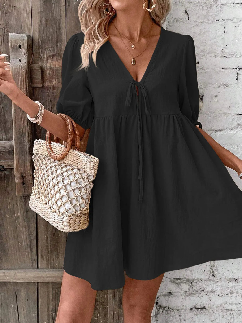 Cotton V-neck tie-front mini dress with puff sleeves, stylish and lightweight, perfect for casual or summer wear.