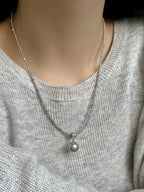 Elegant pearl pendant necklace by Shopimist featuring a single lustrous pearl on a delicate chain.