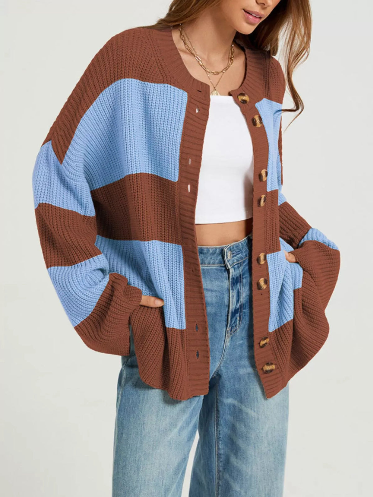 Color block striped button-up cardigan by Trendsi featuring vibrant color blocks and classic button closure on soft knit fabric.
