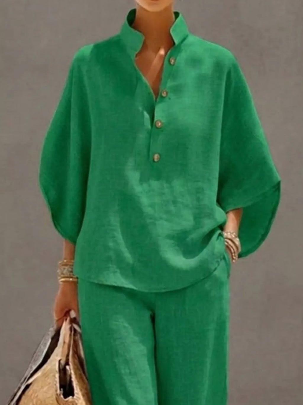 Plus size women's two-piece dress set by Trendsi with button details, featuring a 3/4 sleeve top and matching pants.